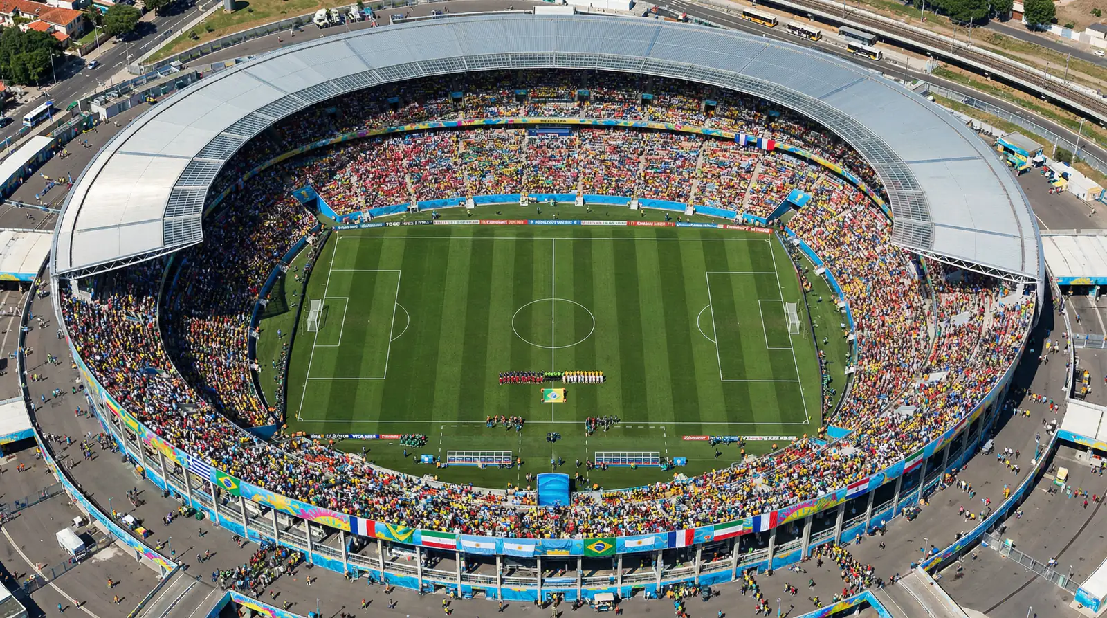 Aerial view of a packed football stadium during a FIFA World Cup group stage match with national flags displayed across the stands
